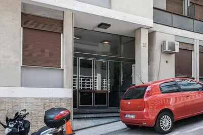 a red car parked in front of a building at Striking Apartments in Kolonaki by UPSTREET in Athens