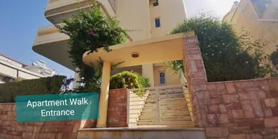 a building with stairs and a sign in front of it at \u5c71\u811a\u4e0b\uff0c\u8212\u9002\u6e29\u99a8\u6d77\u666f\u516c\u5bd3 in Athens
