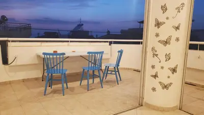 a kitchen with two chairs and a table with butterflies on the wall at \u5c71\u811a\u4e0b\uff0c\u8212\u9002\u6e29\u99a8\u6d77\u666f\u516c\u5bd3 in Athens