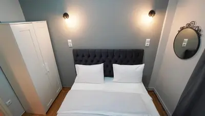 a small room with a bed with two white pillows at Athens City Themis13 in Athens
