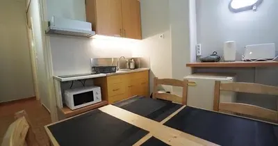 a small kitchen with a table and a microwave at Athens City Themis13 in Athens