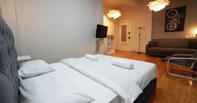 a bedroom with a large bed and a living room at Athens City Themis13 in Athens