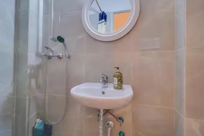 a bathroom with a sink and a mirror and a shower at Central Mini & full renovated Studio @ Syntagma in Athens