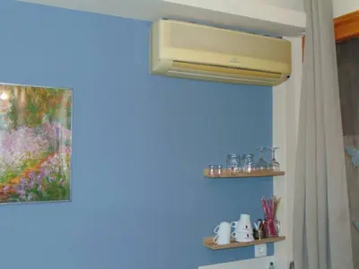 a bathroom with a blue wall with a air conditioner at Central Mini & full renovated Studio @ Syntagma in Athens