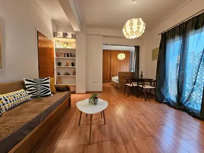 a living room with a couch and a table at Acropolis Museum Suite by YHA in Athens