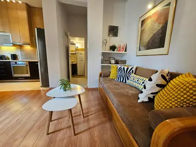 a living room with a couch and a table at Acropolis Museum Suite by YHA in Athens