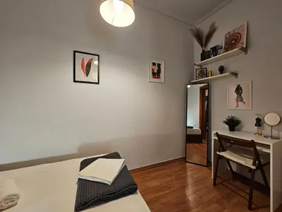 a bedroom with a bed and a table and a desk at Acropolis Museum Suite by YHA in Athens