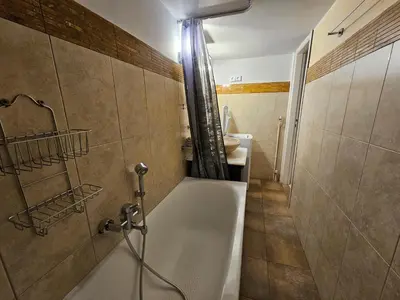 a bathroom with a bath tub and a sink at Acropolis Museum Suite by YHA in Athens