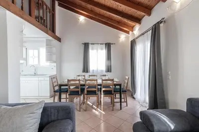a kitchen and dining room with a table and chairs at Blue Riviera villas & suites - Alimos 2 in Athens