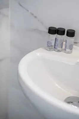 two bottles of medicine sitting on the top of a toilet at Blue Riviera villas & suites - Alimos 2 in Athens