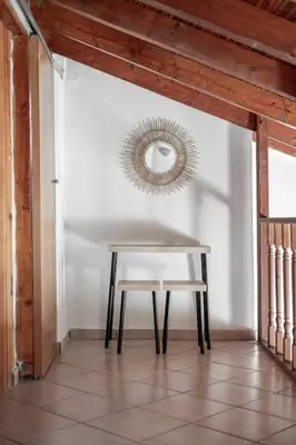 a table and a chair in a room with a mirror at Blue Riviera villas & suites - Alimos 2 in Athens