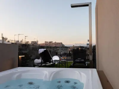 a bath tub with a view of a city at Incanto Boutique Suites - Mets in Athens