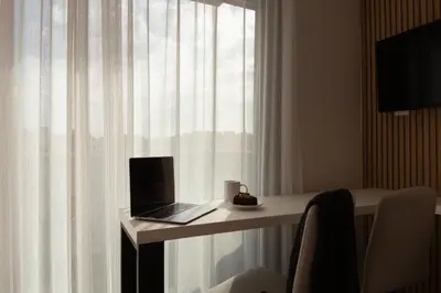 a laptop sitting on a table in front of a window at Incanto Boutique Suites - Mets in Athens