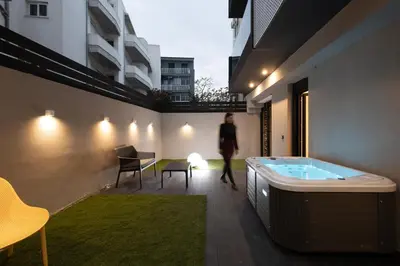 a woman walking through a building with a hot tub at Incanto Boutique Suites - Mets in Athens