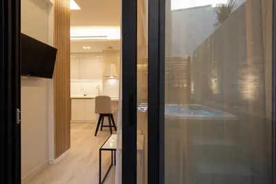 a room with a sliding glass door with a table at Incanto Boutique Suites - Mets in Athens