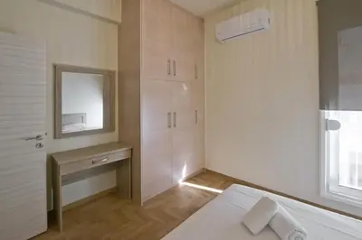 a bedroom with a bed and a mirror and a sink at Koukaki Gem Cozy 1BR Renovated Apt near Center in Athens