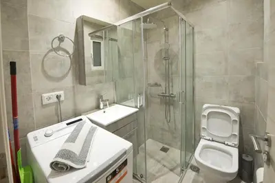 a bathroom with a shower and a toilet and a sink at Koukaki Gem Cozy 1BR Renovated Apt near Center in Athens