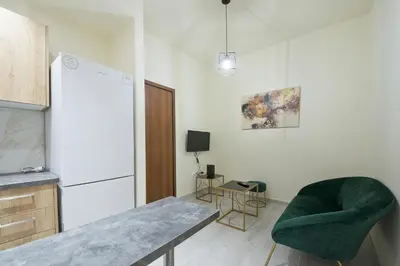 a kitchen with a table and a green chair at Koukaki Gem Cozy 1BR Renovated Apt near Center in Athens
