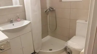 a bathroom with a shower and a toilet and a sink at Flor de Mayo,Apt in Alimos near the sea in Athens