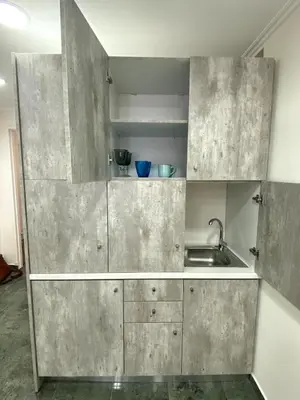 a kitchen with stainless steel cabinets and a sink at Ermou Studio in Athens