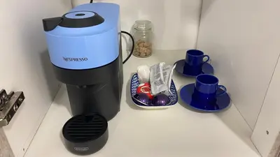 a coffee maker sitting on a counter with cups at Ermou Studio in Athens