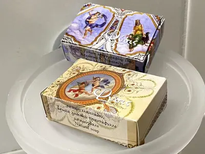 a white plate with a box and a box with at Ermou Studio in Athens