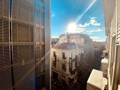 a view of a city from a window of a building at Ermou Studio in Athens