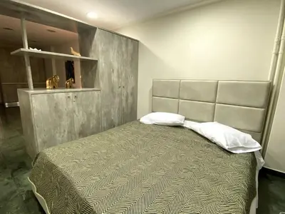 a bedroom with a bed with a large headboard at Ermou Studio in Athens