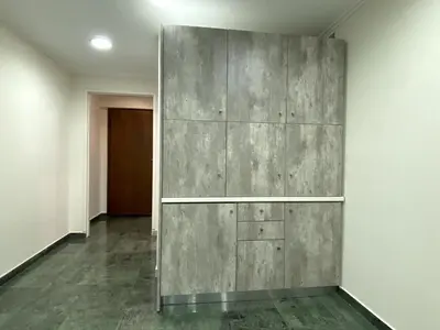 an empty room with a large gray wall at Ermou Studio in Athens