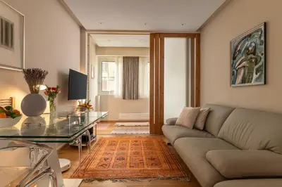 a living room with a couch and a glass table at Zen home in Athens