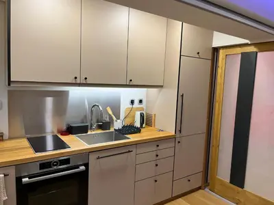 a kitchen with white cabinets and a sink at Zen home in Athens