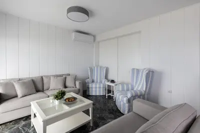a living room with a couch and two chairs at Seaside Bliss Flat in Saronida