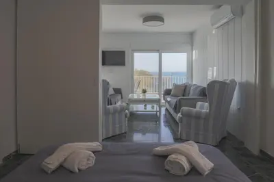 a living room with two towels sitting on a bed at Seaside Bliss Flat in Saronida