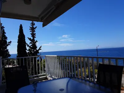 a balcony with a view of the ocean at Seaside Bliss Flat in Saronida