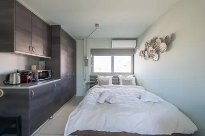 a small bedroom with a bed and a microwave at Acropolis View Mini Sky Suite & Hot Tub in Athens