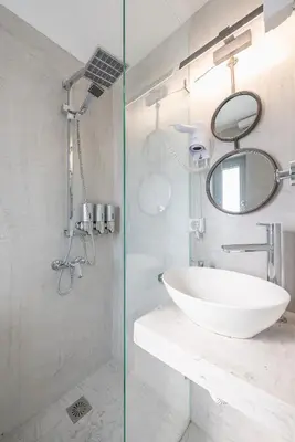 a white bathroom with a sink and a mirror at Acropolis View Mini Sky Suite & Hot Tub in Athens