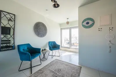 a living room with two blue chairs and a mirror at Acropolis View Mini Sky Suite & Hot Tub in Athens