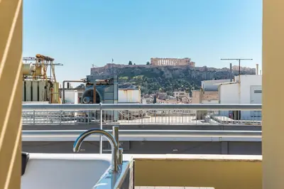 a view of the acropolis from the roof of a building at Acropolis View Mini Sky Suite & Hot Tub in Athens