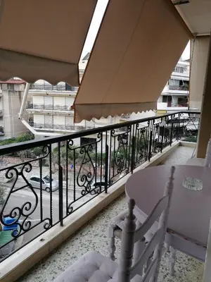 a balcony with a table and a fence at Kalamaki Guest House in Athens