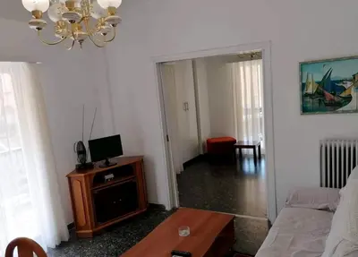 a living room with a couch and a table at Kalamaki Guest House in Athens