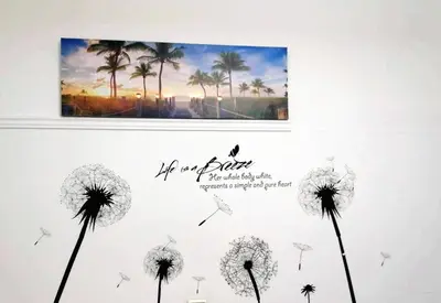a picture of dandelions on a wall with a picture at Kalamaki Guest House in Athens