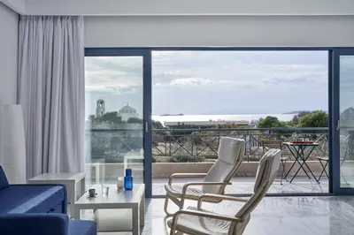 a living room with a blue couch and chairs at Augoustos ECO luxury apartments with pool in Aghia Marina