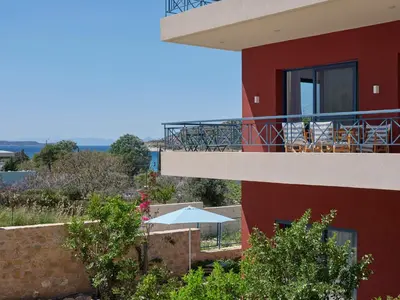 a view of a house with a balcony at Augoustos ECO luxury apartments with pool in Aghia Marina