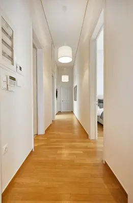 an empty hallway with white walls and wood floors at Chloe Boutique Apartments Plaka in Athens