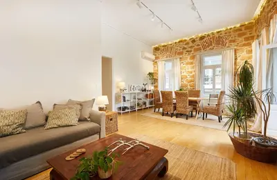 a living room with a couch and a table at Chloe Boutique Apartments Plaka in Athens