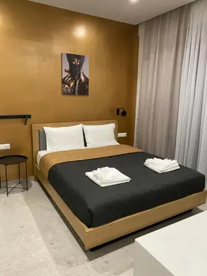 a bedroom with a bed with two towels on it at Smart Lux Apartment B in Athens
