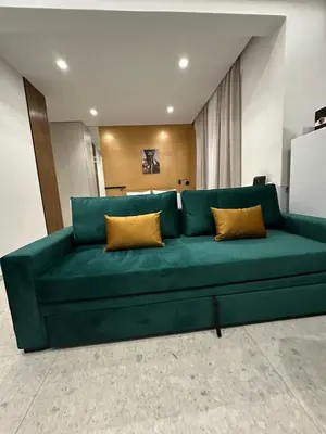 a green couch with two pillows in a room at Smart Lux Apartment B in Athens