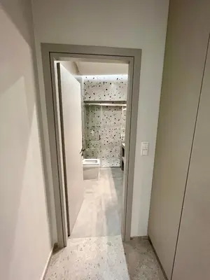 a hallway with a door leading to a bathroom at Smart Lux Apartment B in Athens