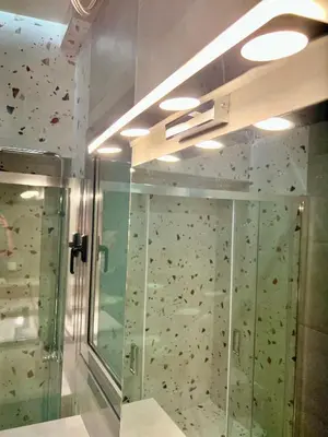 a rock climbing wall in a room with a shower at Smart Lux Apartment B in Athens
