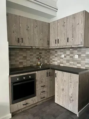 a kitchen with wooden cabinets and a sink at Monastiraki 101 SuperHost Hub in Athens